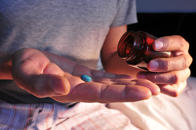 man taking blue pill